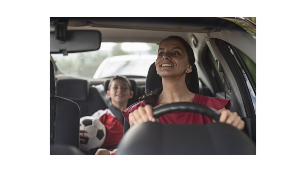 A mom and kids in a car listening to an audiobook on the way to soccer practice.