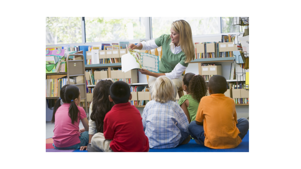 A librarian reading to a group of kids in the summer.