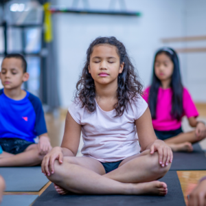 Children learning to breathe deeply as a management strategy to overcome anxiety.