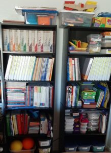 Homeschool teacher supplies on shelves