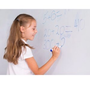 Girl adding on a whiteboard.